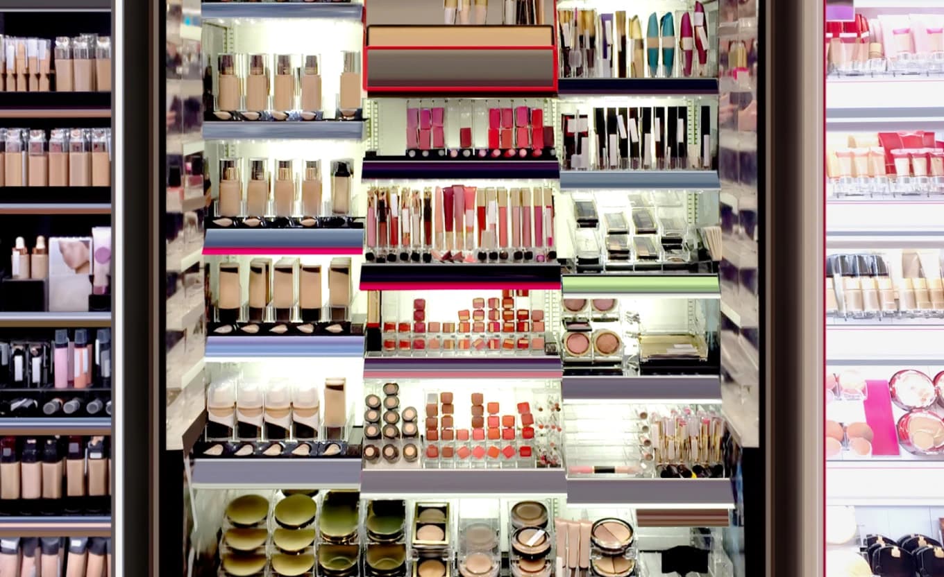 Cosmetics display wall stocked with beauty products at a salon retail counter.