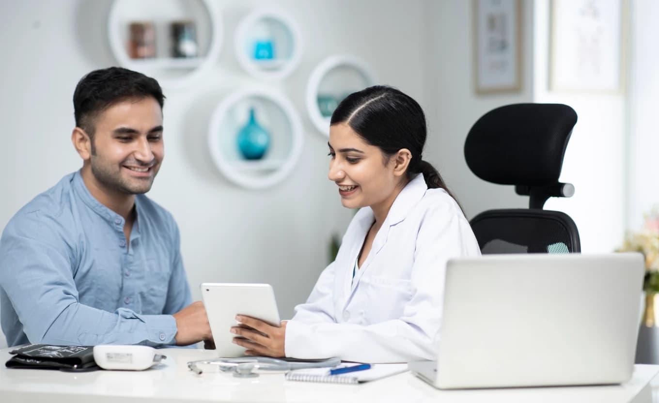 Medical representative detailing a product to a doctor during a clinic visit.